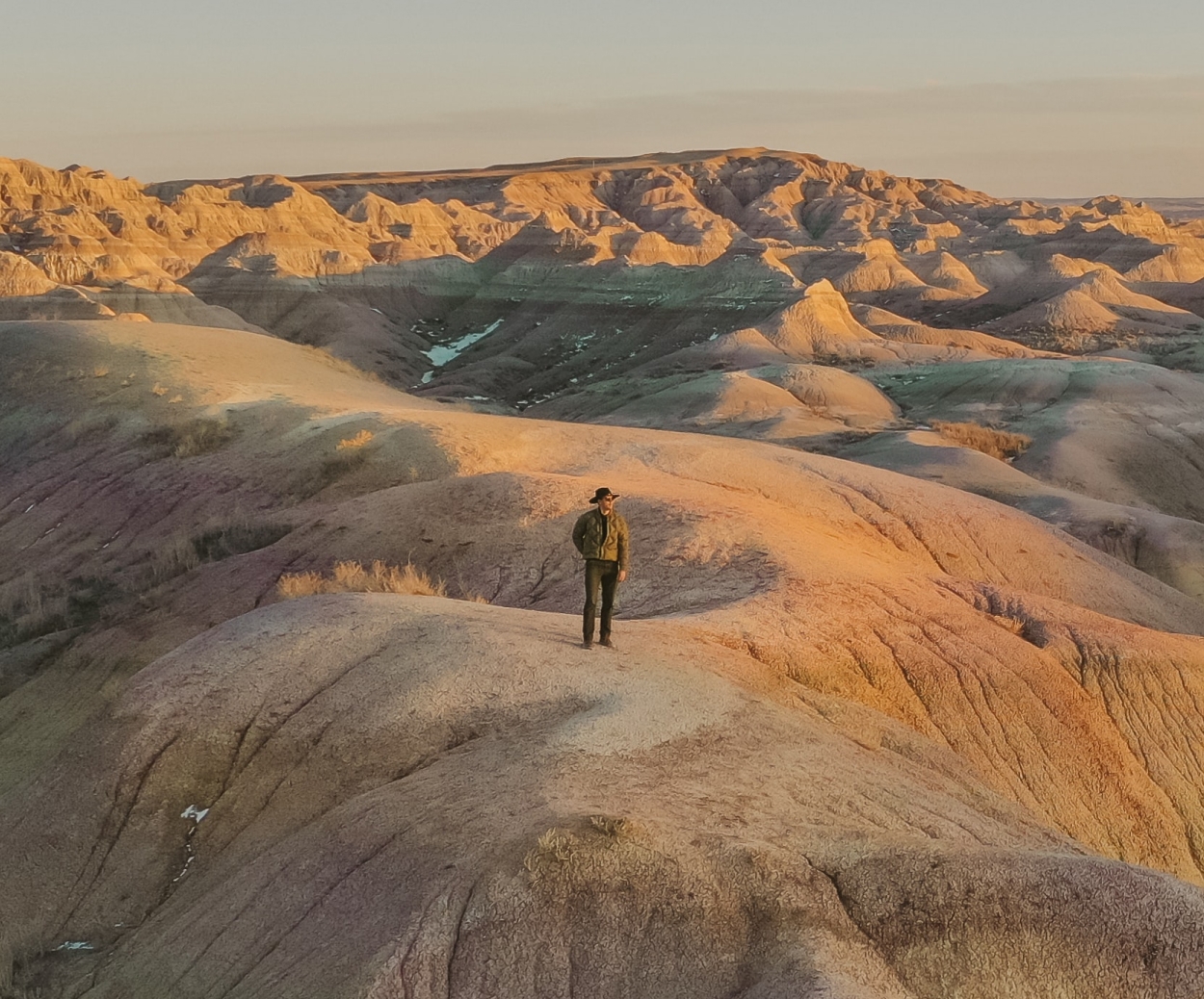 A man standing on a desert stone crag